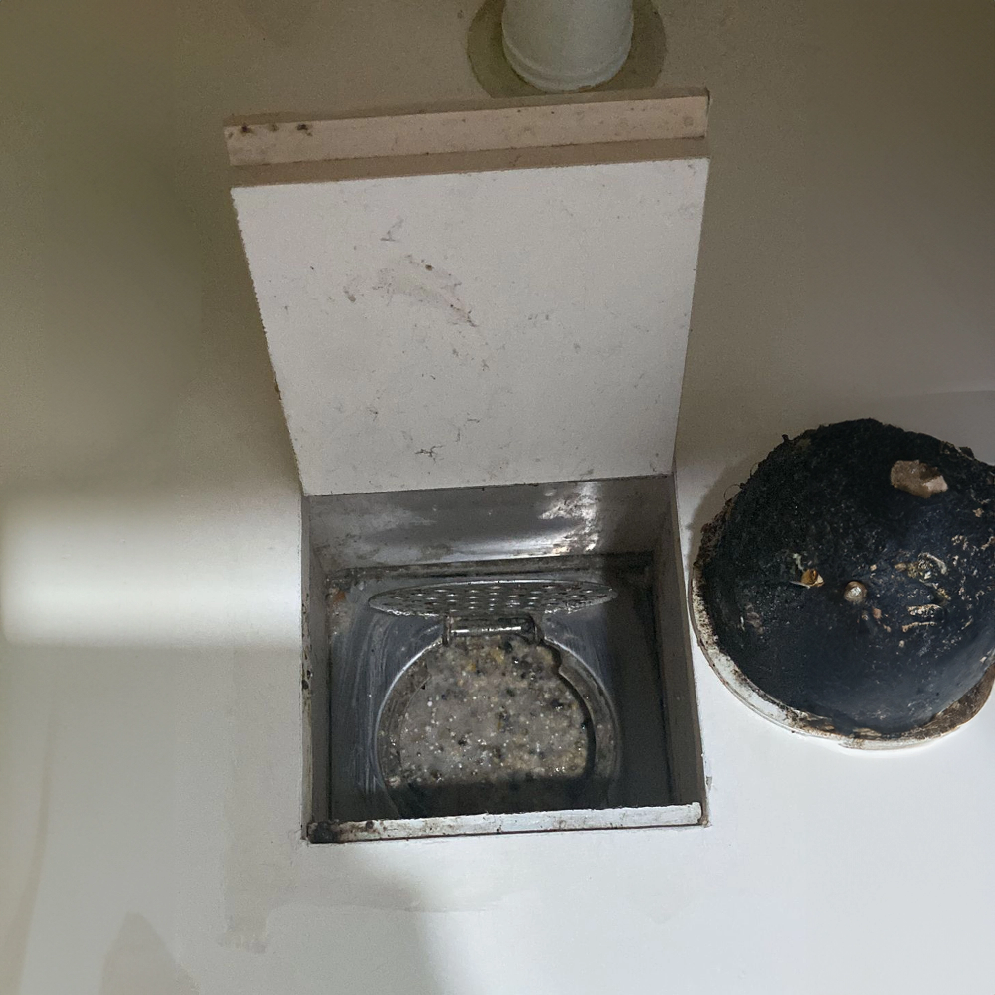 Kitchen floor trap clogged with grease and food waste