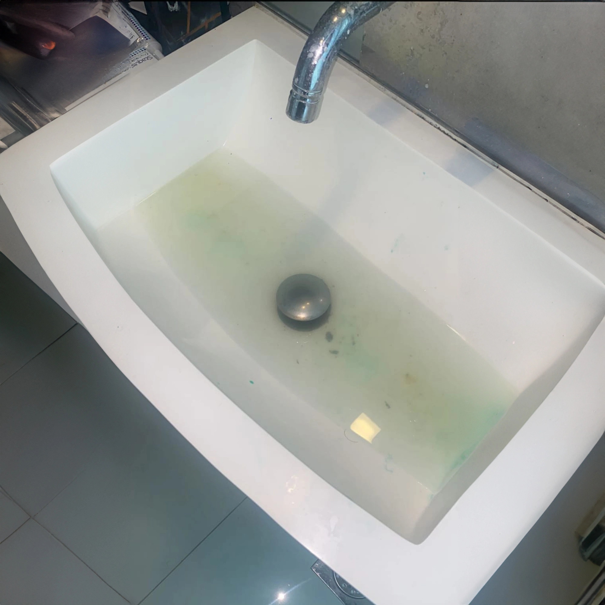 Clogged bathroom sink/basin preventing water from draining